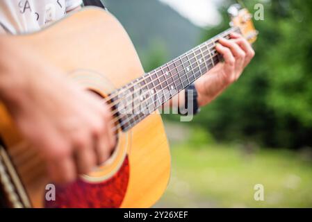 A young man plays the guitar. Stock Photo