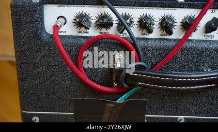 Guitar amplifier with a red cable. Stock Photo