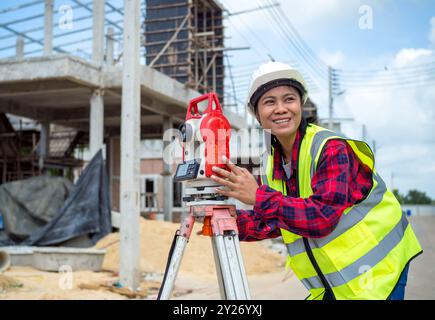 Surveyor and survey equipment on construction site, Land and soil development, Survey equipment, Theodolite for measurement construction work, Civil e Stock Photo
