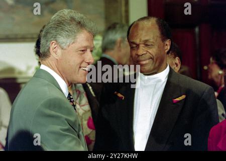 U.S President Bill Clinton, left, greets D.C Mayor Marion Barry, right, after signing a rescue package for the District of Columbia at the Roosevelt Room of the White House, April 17, 1995 in Washington, D.C. The legislation establishes an oversight board and financial aid to prevent bankruptcy for the capital city. Stock Photo