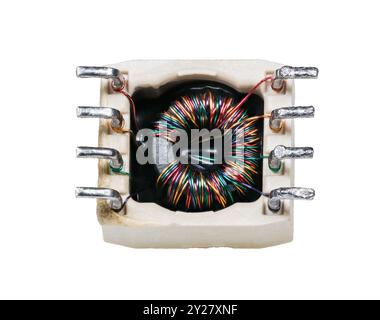 Toroidal transformer with colored wire on ferrite core isolated on a white background. Closeup of electronic inductor embedded in square ceramic case. Stock Photo