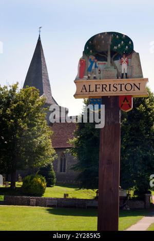 Alfriston village sign and spire of St Andrews church, East Sussex, England Stock Photo