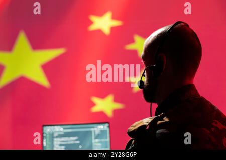 China army dispatcher in headquarters ready to respond to emergencies and communicate with troops on front lines. Chinese war telecommunications operator transmitting orders from CCP government Stock Photo