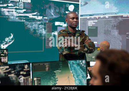 African American commander in camouflage speaking and pointing at ...