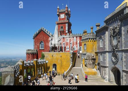 Colourful palace with red and yellow facades, many visitors and stairs, Palacio Nacional da Pena, National Palace Pena, Sintra, Lisbon, World Heritage Stock Photo