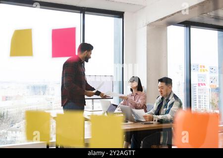 Meeting of creative professionals in modern office setting Stock Photo