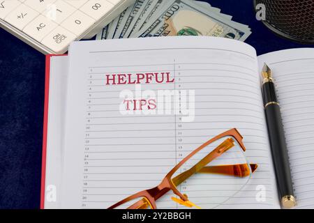Helpful Tips words writing in a notebook on a dark background Stock Photo