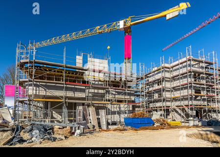 Construction site with crane, scaffolding and shell of an unfinished building Stock Photo