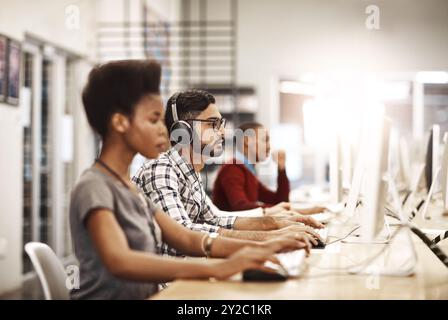 Computer, group and students at library for research, knowledge and test results in college. University learning, diversity and internet for education Stock Photo
