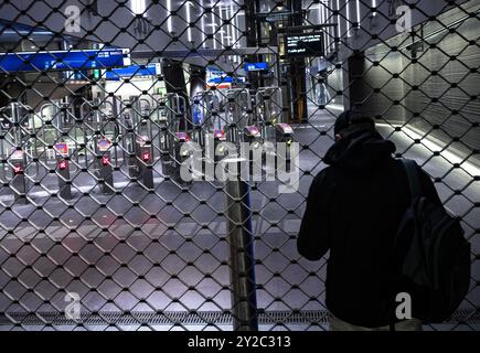 AMSTERDAM - A passenger stands in front of a closed subway station at Amsterdam Central Station during a work stoppage in Amsterdam's city transport system. From 4 a.m. to 8 a.m., streetcars, buses and subways were not running. Trade union FNV has announced several strikes in the week before Budget Day. The goal is to urge the cabinet to come up with a regulation that would allow ov employees to quit heavy work earlier. ANP RAMON VAN FLYMEN netherlands out - belgium out Stock Photo