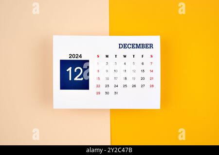 December Calendar 2024 page on yellow color background. Stock Photo