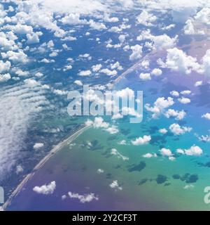 Aerial view from plane flying over Ijmuiden port city close to Amsterdam, Netherlands showing the rainbow effect of birefringence through plane window Stock Photo