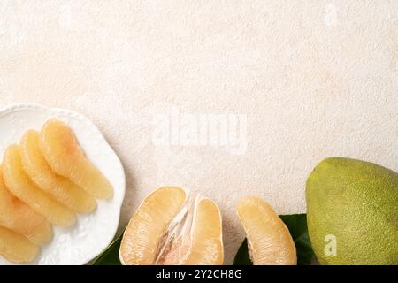 Fresh peeled pomelo with leaf on white table background for Mid-Autumn Festival fruit. Stock Photo