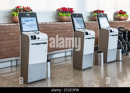 Airport Check-in Self service machine at airport for check in, printing boarding pass or buying ticket. Flight ticket registration, online boarding pa Stock Photo