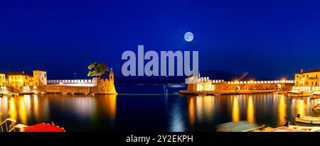 Panorama of Nafpaktos port during blue hour against the full moon. Stock Photo