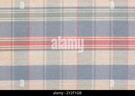 Geometric fabric check pattern background consisting of thin and thick, unevenly spaced stripes of alternating pastel colors in blue red green Stock Photo