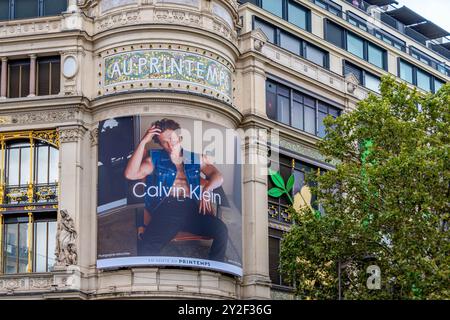 Advertising billboard  for Calvin Klein starring actor Jeremy Allen White on the facade of the Printemps, a French department store of Paris, France Stock Photo