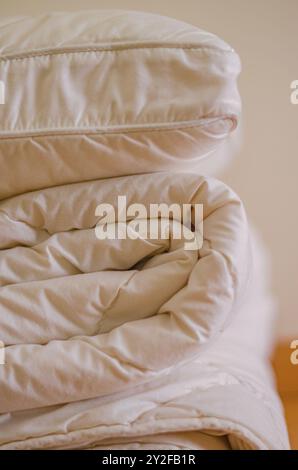 side view of Stack of beddings , white pillow on the duvet . High quality photo Stock Photo