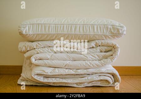 Soft stack folded blanket and pillows on the wooded floor in room . High quality photo Stock Photo