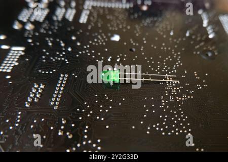 Green LED or Light Emitting Diode standing on the high technology patterned floor. Stock Photo