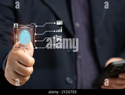 A man scans his fingerprint to verify his identity when making a business transaction on his smartphone, using a credit card online, shopping online, Stock Photo