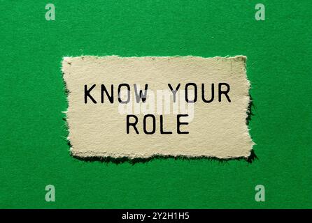 Know your role message written on ripped torn paper piece on green background. Conceptual know your role symbol. Copy space. Stock Photo