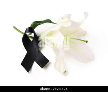 Beautiful lily flower with black funeral ribbon on white background Stock Photo