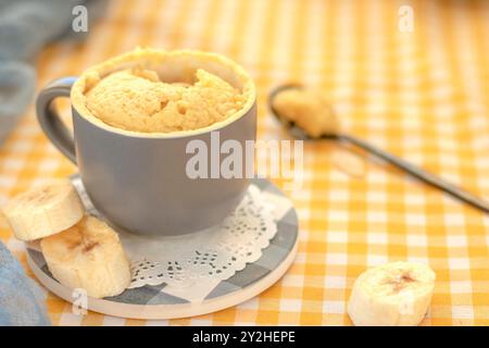 mini cake. Breakfast in a mug. homemade Portioned Banana mugcake in small mugs. Stock Photo