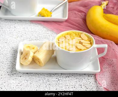 mini cake. Breakfast in a mug. homemade Portioned Banana mugcake in small mugs. Stock Photo