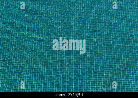 Turquoise colored bottom of swimming pool filled with water Stock Photo