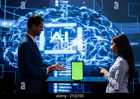 Engineer and supervisor use AI machine learning to extract information from complex data on isolated screen tablet. Experts in workspace use artificial intelligence technology on chroma key device Stock Photo