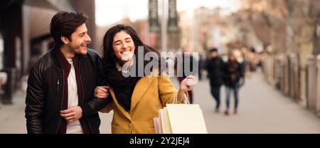 Excited couple doing shopping on weekend together Stock Photo