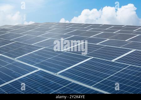 A solar panel is shown in the image, with the sun shining on it. The solar panel is blue and has a grid pattern. Concept of sustainability and environ Stock Photo