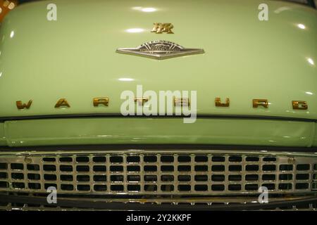 Wartburg Car Hood with Gold Lettering and Emblem. High quality photoA close-up of a Wartburg car hood reveals a smooth, vintage surface, with bold gol Stock Photo