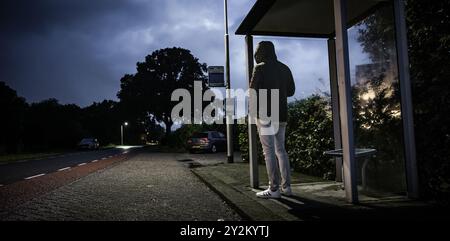 SOMEREN - A traveler at a bus stop during a strike by regional transport companies. Trade union FNV has organized several strikes. The goal is to urge the cabinet to come up with a regulation that would allow ov workers to quit heavy work earlier. ANP ROB ENGELAAR netherlands out - belgium out Stock Photo