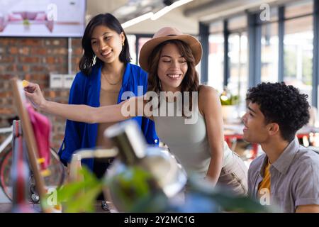 At office, Collaborating on interior design, diverse team discussing ideas and pointing at screen Stock Photo