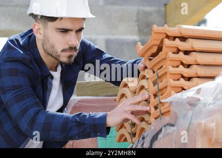 man in builder choosing tiles Stock Photo