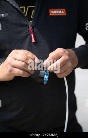 Ivano-Frankivsk, Ukraine, May 10, 2024: A man winds electrical tape on a cable. Stock Photo