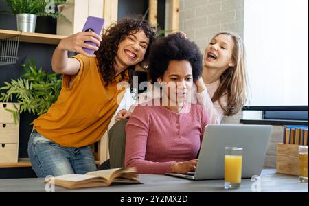Busy working black mother doesn't have time for her children. Working from home concept. Stock Photo
