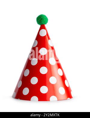 Classic red party hat with white polka dots and green pompom standing isolated  on white background Stock Photo