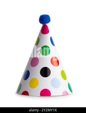 Classic white party hat with multi coloured polka dots and blue pompom standing isolated  on white background Stock Photo