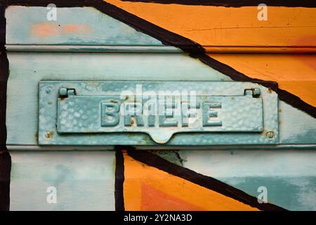 Old colorful letterbox at a door in germany. Stock Photo