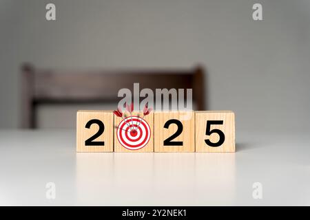 2025 business goals. Wooden block with 2025 word and target icon. set up objective target business cost and budget planning for new year concept. Stock Photo