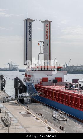 A general cargo ship sails into the port of Qingdao, a port in Shandong ...