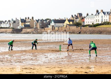 People playing Cricket on the Beach in Elie, Fife, Scotland Stock Photo