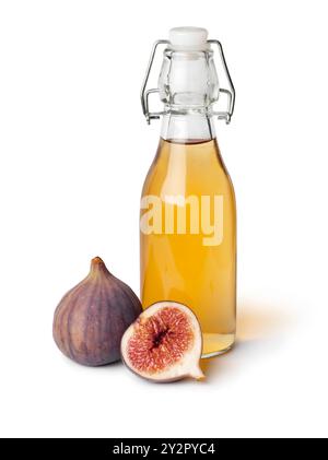 Glass bottle with homemade fig vinegar and fresh figs close up isolated on white background Stock Photo