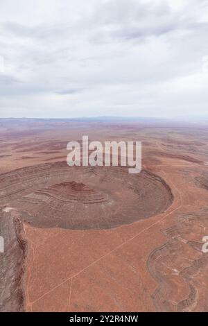 From above, this image captures the Rio San Juan gracefully curving through the rugged terrain of San Juan Canyon, near Mexican Hat, Utah. The vast an Stock Photo