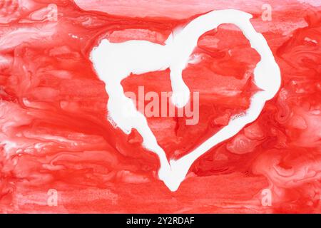 Abstract heart-shaped background mixing red and white paints. Stock Photo