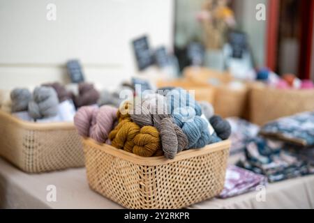 Yarn for knitting coloured in soft earth tones for sale displayed on a market stall in rural Sweden Stock Photo