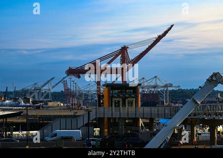 The Cranes On The Waterfront And Harbor Island In Seattle Washington From The New Coleman Ferry Dock With A Nice Sky Stock Photo